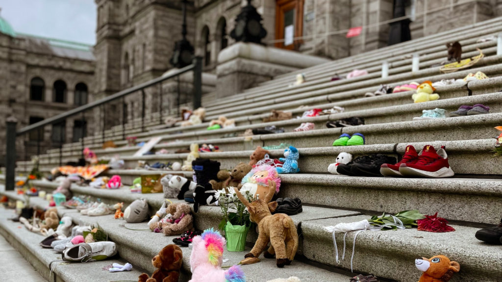 A photo of stuffed animals, shoes and other items left to honour the Indigenous children found in unmarked graves.