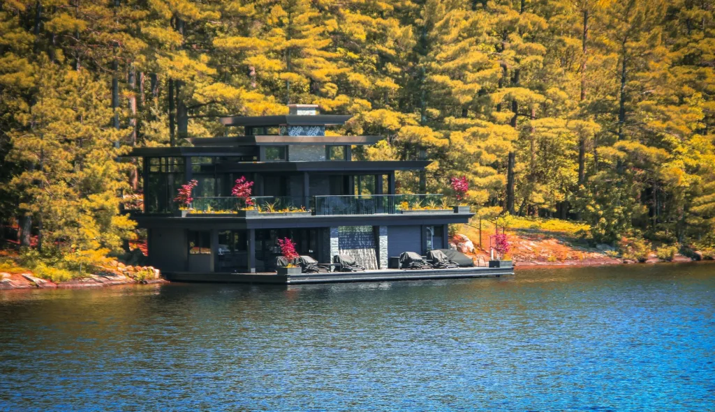 A luxury cottage sits along the water in Muskoka